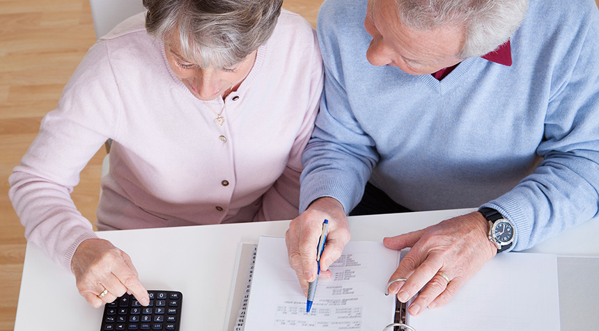 Elderly couple doing taxes together